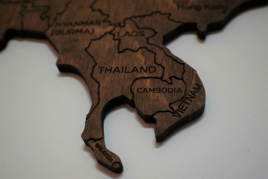 Intricate wooden map piece featuring Southeast Asia with country names engraved.